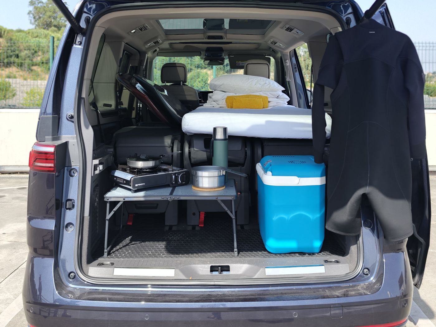 Multivan in camper mode — bed, kitchen and cooler ready
